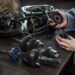 female mechanic holding spare parts of car