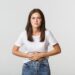 woman having stomach ache, bending and holding hands on belly, discomfort from menstrual cramps. girl feeling nauseous
