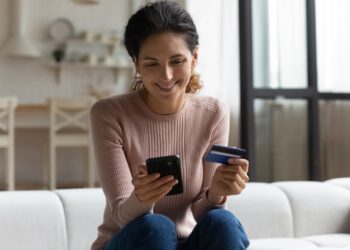safe,mobile,banking.,smiling,latina,lady,client,hold,mobile,phone