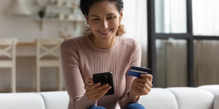 safe,mobile,banking.,smiling,latina,lady,client,hold,mobile,phone