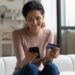 safe,mobile,banking.,smiling,latina,lady,client,hold,mobile,phone