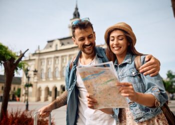 happy,couple,enjoying,in,travel,while,exploring,a,map,during