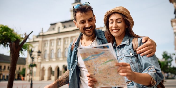 happy,couple,enjoying,in,travel,while,exploring,a,map,during