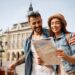 happy,couple,enjoying,in,travel,while,exploring,a,map,during
