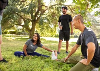 group stretching before yoga exercise in the park (1)