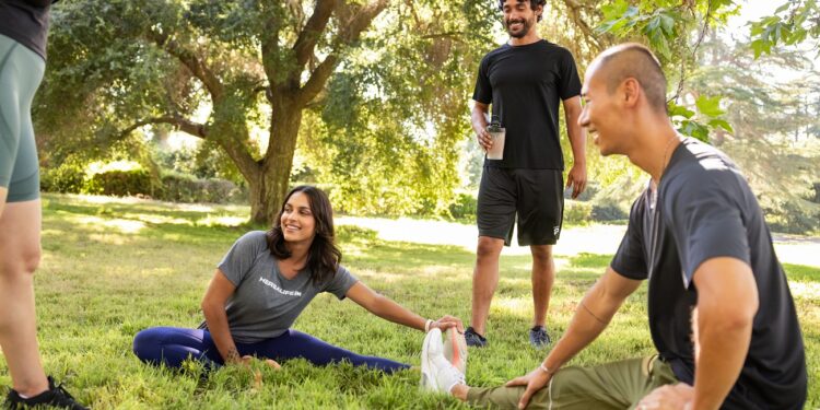 group stretching before yoga exercise in the park (1)