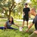 group stretching before yoga exercise in the park (1)
