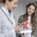 medium shot doctor explaining anatomic model