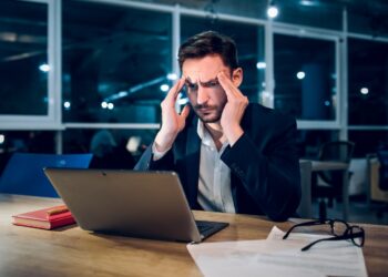 handsome businessman with laptop working latenight.