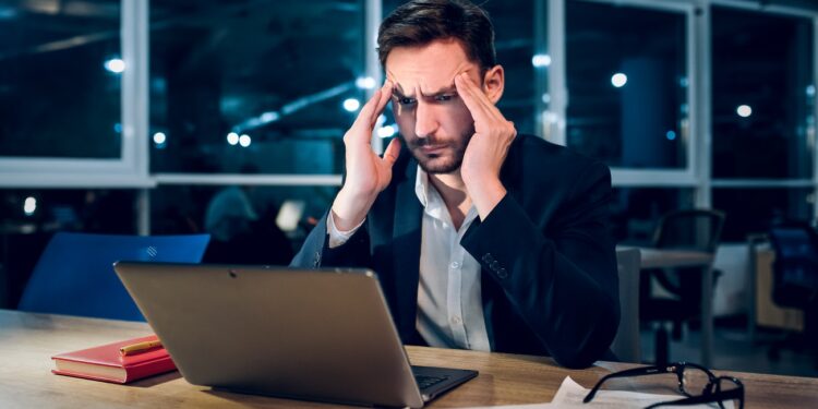 handsome businessman with laptop working latenight.