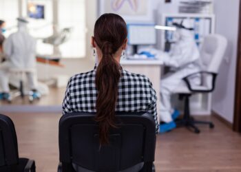 back view of woman in dentist office waiting for consultation