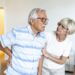 senior couple at home.elderly man is having back pain and his lovley wife supports him.