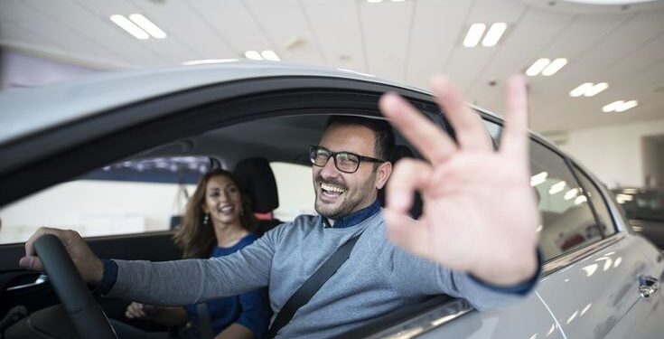 happy customer buying new car at dealership.