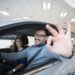 happy customer buying new car at dealership.