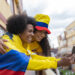afro latin couple is outside their house watching the soccer game through their tablet