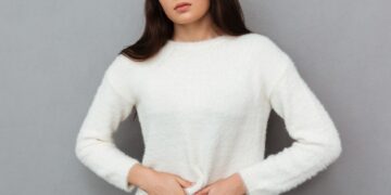 close up photo of depressed young woman with abdominal pain, loo