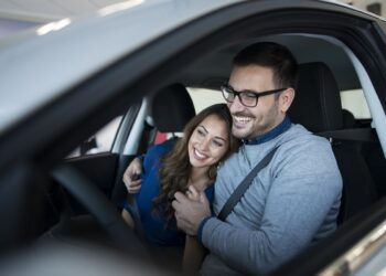 happy young couple enjoying their brand new car.