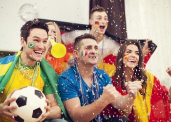 multinational football supporters celebrating goal