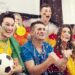 multinational football supporters celebrating goal