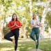 women concentrating during their yoga workout in the park