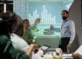 management team sharing insight on statistics in night corporation meeting