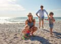 happy,,parents,and,children,playing,on,the,beach,on,family