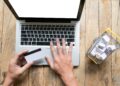 man holding credit card in hand and entering security code using